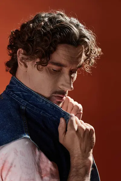 A striking portrait of a handsome man showcasing deep emotion on a vivid backdrop. — Stock Photo