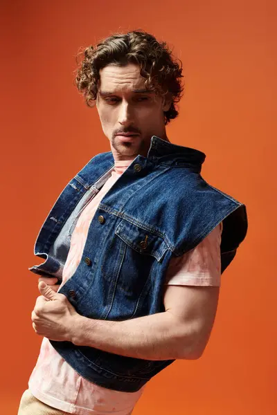 A man strikes a confident pose, showcasing his emotions against a lively background. — Stock Photo