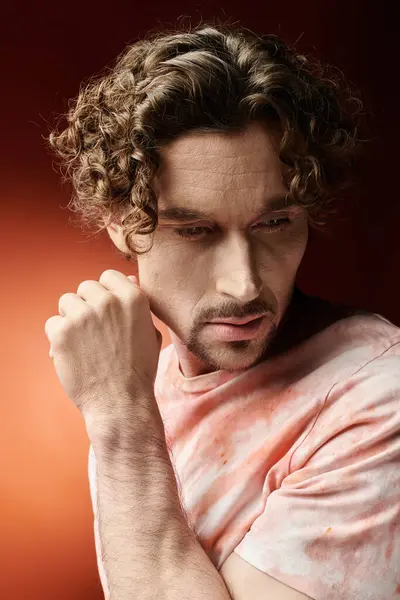A handsome man conveys deep emotions amidst a striking background. — Stock Photo