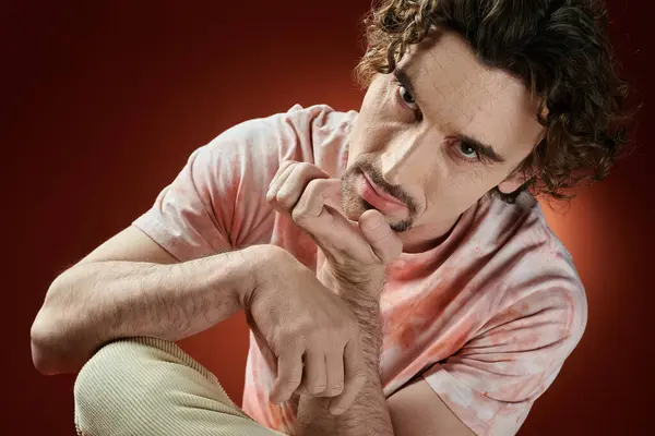 A handsome man expresses deep emotions while posing creatively. — Stock Photo