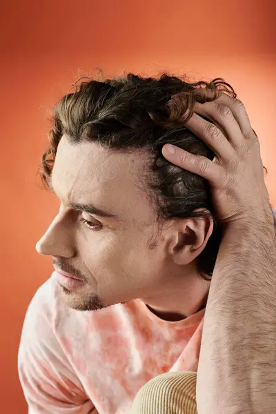 A striking portrait of a man lost in thought with a vibrant background. — Stock Photo