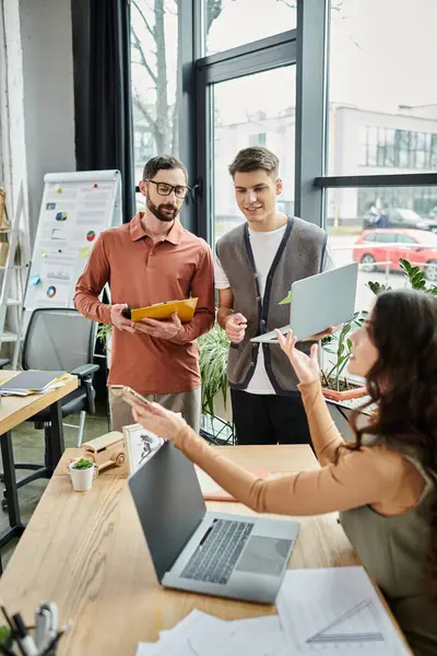 Team members engage in conversation in office. — Stock Photo
