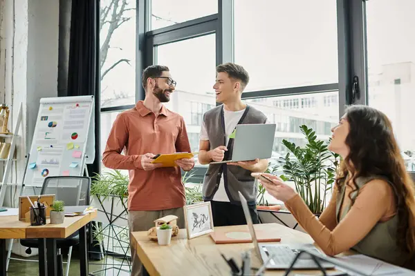 Talented professionals in casual attire discussing work in office. — Stock Photo