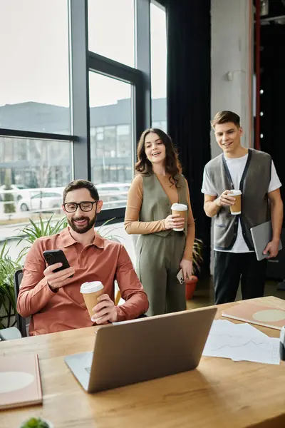 Good looking colleagues engage in lighthearted conversation with coffee in hand. — Stock Photo