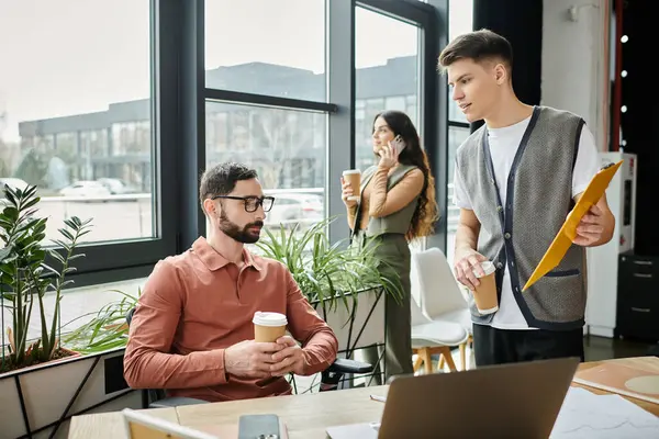 Colleagues engage in conversations in modern office. — Stock Photo