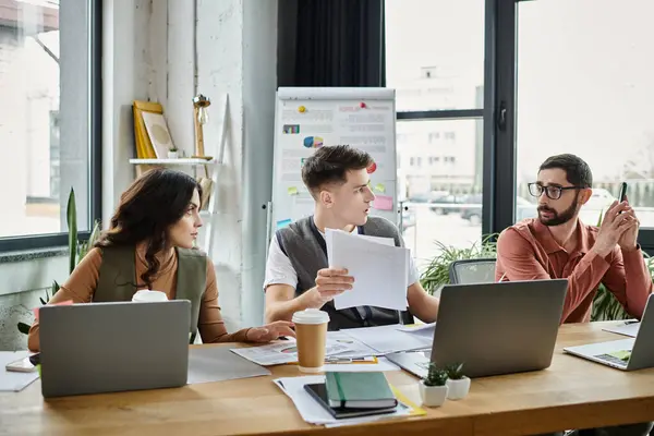 Colleagues in casual elegant attire discuss important documents at work. — Stock Photo
