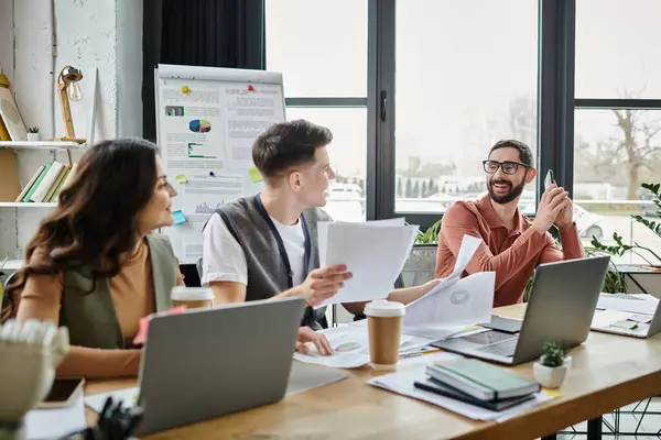 Professionals collaborate thoughtfully in a casual workspace. — Stock Photo