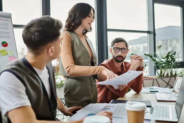 Colleagues review documents while at a modern workspace. — Stock Photo