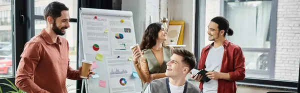 A group of colleagues engages in light conversation. — Stock Photo