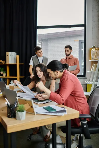 Team members engage in candid conversation in office. — Stock Photo