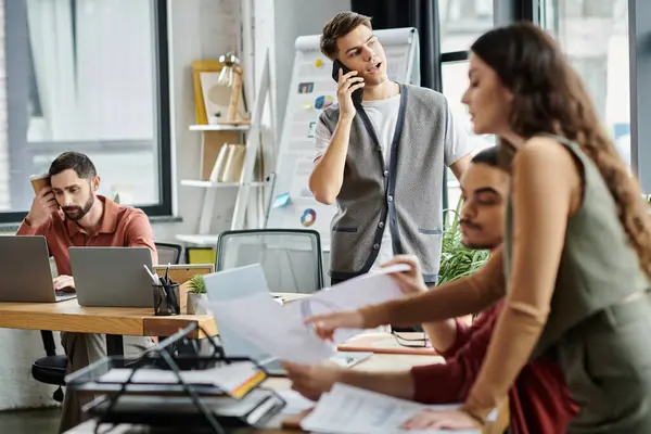 Professionals engage in discussions in office. — Stock Photo