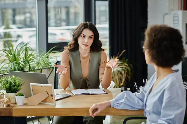 Colleagues engage in a serious discussion about job changes during a challenging time. — Stock Photo