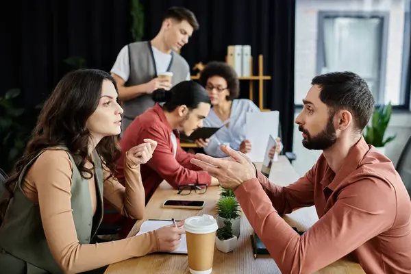 Team members converse seriously in a modern office setting about work. — Stock Photo