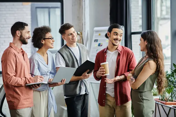 Team members converse amicably in a stylish workspace during a challenging time. — Stock Photo