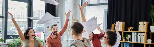 Professionals share a joyful moment, tossing papers during a challenging time. — Stock Photo