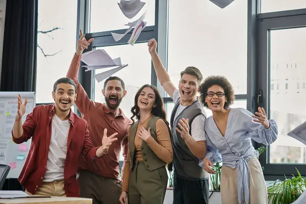 Team members joyfully embrace change while expressing hope in a bright office setting. — Stock Photo