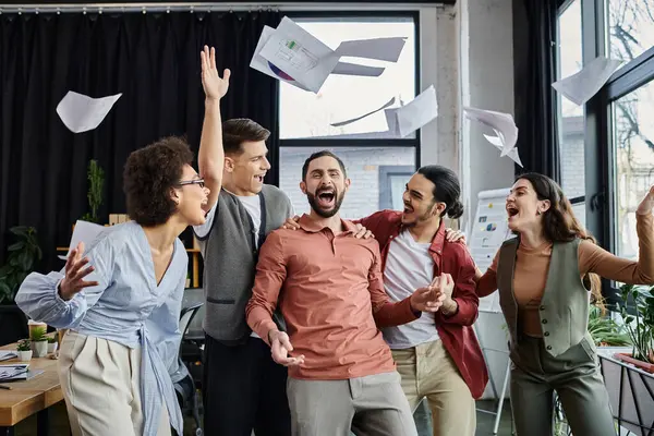 A group of colleagues joyfully celebrate together in office. — Stock Photo