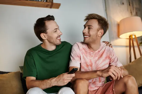 Two men share smiles and laughter in a warm and inviting home environment. — Stock Photo