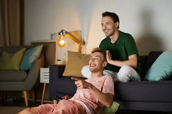 Two men enjoy their cozy evening, sharing laughter and warmth together. — Stock Photo