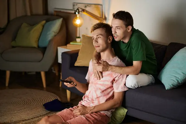 Two men share a tender moment while relaxing on the couch. — Stock Photo