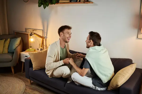 Loving couple enjoying each other while sitting on a comfortable couch. — Stock Photo