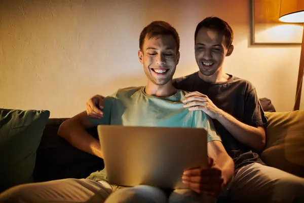 Happy moments shared by two men while enjoying a laptop together. — Stock Photo