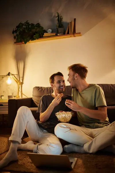 Two men share a playful moment while watching a movie at home. — Stock Photo