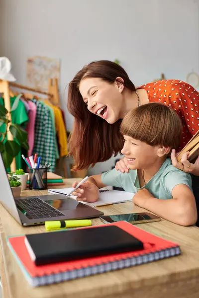 A mother and her hearing impaired son joyfully engage in a creative activity together. — Stock Photo
