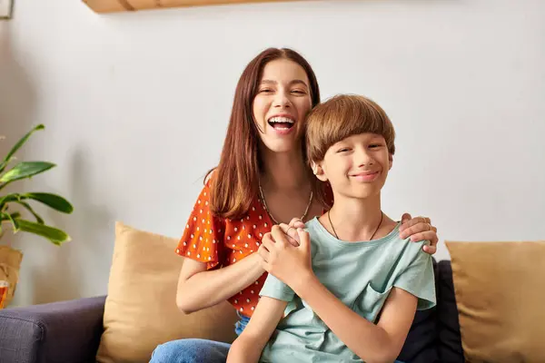 A mom and her hearing impaired son enjoy a joyful moment in their cozy living room. — Stock Photo