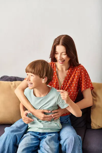 A joyful mother and her hearing impaired son bond over laughter and play. — Stock Photo