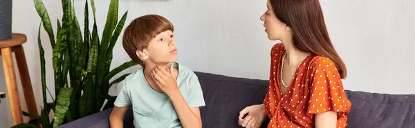 A mother and her son engage in a tender conversation together. — Stock Photo
