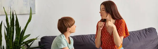 A mother engages with her hearing impaired son through joyful interaction. — Stock Photo