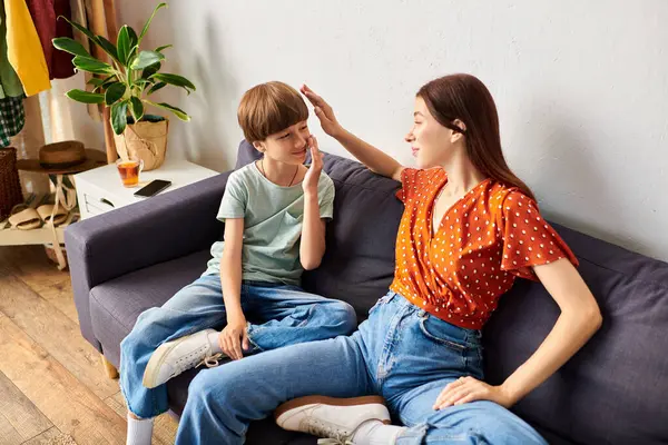 A mother interacts happily with her hearing impaired son in their living space. — Stock Photo