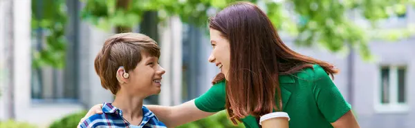 A mother shares a delightful conversation with her hearing impaired son. — Stock Photo