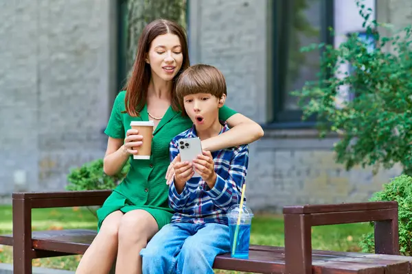A mother and her son share a moment of wonder as they explore a device together. — Stock Photo