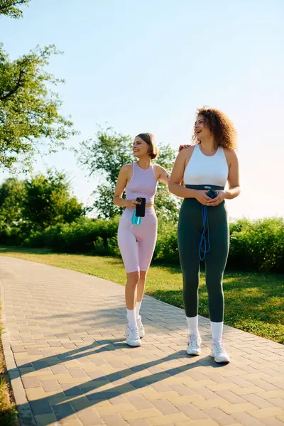 A couple shares laughter and moments during their park workout. — Stock Photo