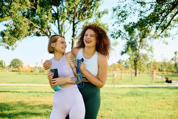 Two women share a happy moment outdoors, filled with laughter and affection. — Stock Photo