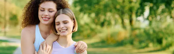Two women embrace happily while enjoying a beautiful day outdoors. — Stock Photo
