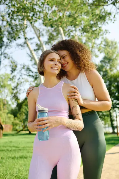 Two women share affectionate smiles while enjoying nature together. — Stock Photo