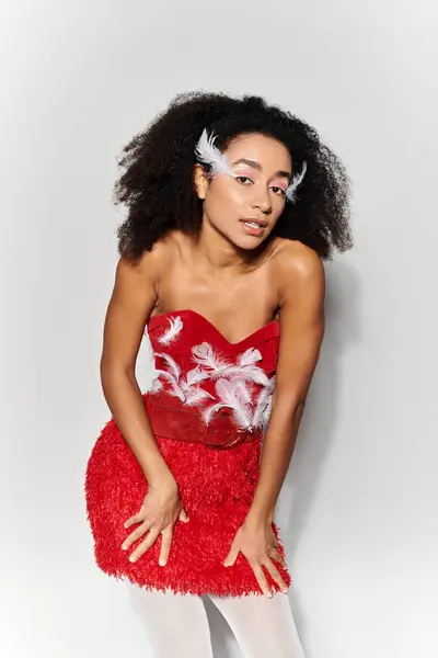 A stylish young woman showcases her unique fashion sense in a vibrant red ensemble. — Stock Photo