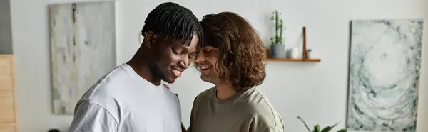 A joyful gay couple smiles at each other, enjoying a quiet moment together indoors. — Stock Photo