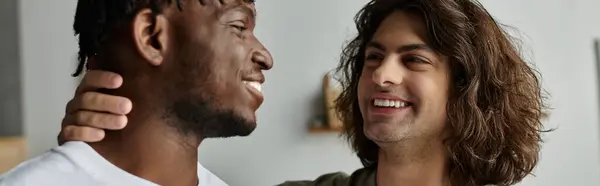 A loving gay couple embraces each other, radiating joy in their cozy home atmosphere. — Stock Photo