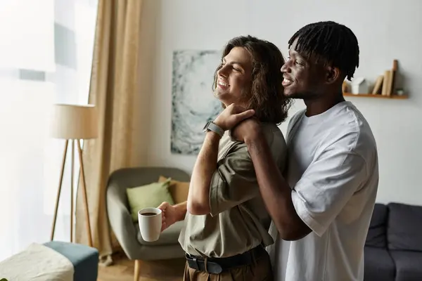 A joyful couple embraces each other warmly, enjoying a tender moment at home in the morning light. — Stock Photo