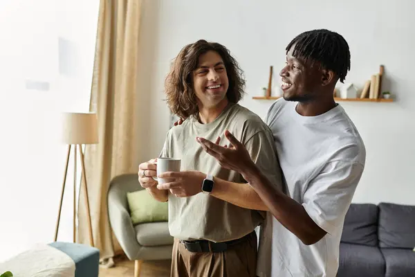 Two men share laughter and love while relaxing at home, creating a warm and joyful atmosphere. — Stock Photo