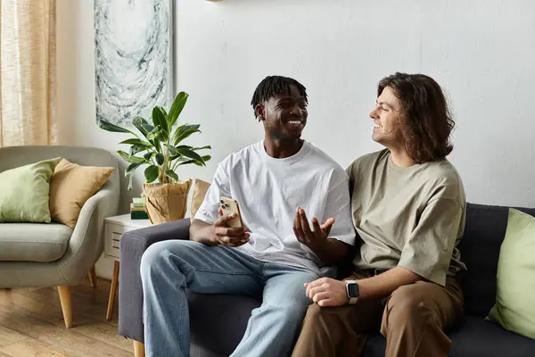 Two partners express love and laughter while enjoying a relaxed day in their bright living room. — Stock Photo