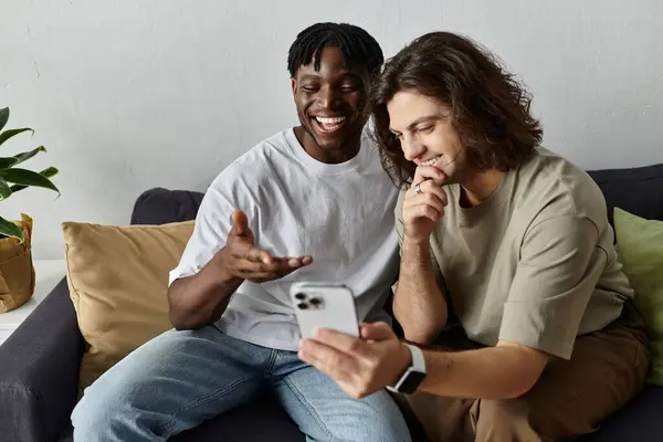 Two partners express happiness while enjoying a light hearted moment at home. — Stock Photo