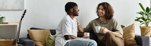 Two partners enjoy a joyful moment, savoring coffee and each other in their space. — Stock Photo