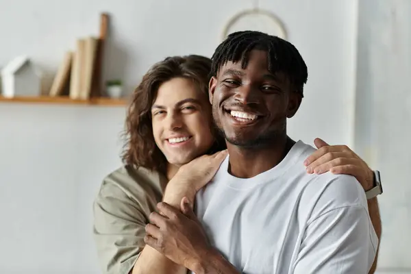 A loving couple embraces warmly at home, sharing smiles and connection in their cozy space. — Stock Photo