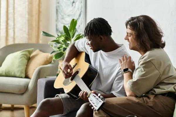 A loving couple shares a warm afternoon, playing guitar and enjoying each other. — Stock Photo