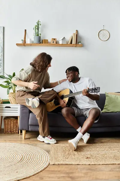 Two partners share a heartfelt afternoon, playing guitar and making lovely memories. — Stock Photo